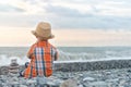Kid plays on the beach with pebbles Royalty Free Stock Photo