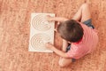 Kid plays with double-sided Interhemispheric board on floor