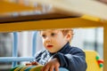 The kid plays in a nursery. Children are enjoying playground equipment Royalty Free Stock Photo