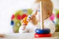 The kid plays the pyramid. child playing with toys Royalty Free Stock Photo