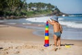 Kid plays with toys at the seashore in summertime Royalty Free Stock Photo