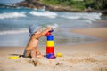 Kid plays with toys at the seashore in summertime Royalty Free Stock Photo