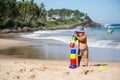 Kid plays with toys at the seashore in summertime Royalty Free Stock Photo