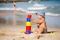 Kid plays with toys at the seashore in summertime Royalty Free Stock Photo