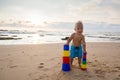 Kid plays with toys at the seashore in summertime Royalty Free Stock Photo