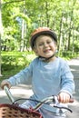 Kid portrait with bike and helmet in the publick park Royalty Free Stock Photo