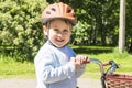 Kid portrait with bike and helmet smiles in the publick park Royalty Free Stock Photo