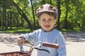 Kid portrait with bike and helmet smiles in the publick park Royalty Free Stock Photo