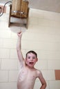 Kid pouring water on himself from bucket Royalty Free Stock Photo