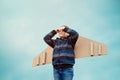 Kid pretend to be pilot. Child with wings airplane. Summer vacation