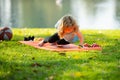 Kid pushing up. Boy doing push up exercise outdoors. Healthy lifestyle in nature. Gymnastic for children.