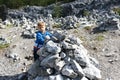 Kid puts stones in heap in marble canyon Royalty Free Stock Photo