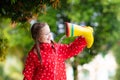 Kid with rain boots. Waterproof wear for children