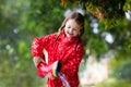 Kid with rain boots. Waterproof wear for children