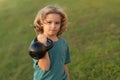 Kid raising a kettlebell. Cute child training with dumbbells. Kids fitness. Kid boy exercising with dumbbells. Healthy Royalty Free Stock Photo