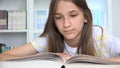 Kid Reading Book, Child Studying in School Library, Adolescent Student Girl, Teenager Learning in Classroom, Children Education Royalty Free Stock Photo