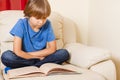 Kid reading a book at home