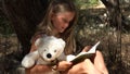 Kid Reading Book by Tree in Park, Schoolgirl Enjoying Outdoor Child Studying in Nature, Teenager Girl Relaxing in Forest Education Royalty Free Stock Photo