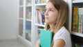 Kid Reading Books, Student Child in School Library, Teenager Blonde Girl Studying Learning in Classroom Royalty Free Stock Photo