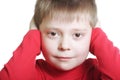 Kid in red closing ears Royalty Free Stock Photo
