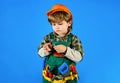 Kid repairman with toolbelt with wrench. Little kid in builder uniform with spanner. Child game. Boy construction worker Royalty Free Stock Photo