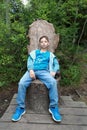 Kid resting on stump chair Royalty Free Stock Photo