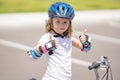 Kid ride bike. Child riding bicycle. Little kid boy in helmet on bicycle along bikeway. Happy cute little boy riding Royalty Free Stock Photo