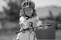 Kid ride bike. Child riding bicycle. Little kid boy in helmet on bicycle along bikeway. Happy cute little boy riding Royalty Free Stock Photo