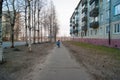 The kid rides alone on a bicycle on an empty spring street of the provincial city. Social distance due to quarantine, coronavirus Royalty Free Stock Photo