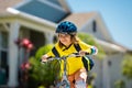 Kid riding bike in a helmet. Child riding bike in protective helmet. Safety kids sports and activity. Happy kid boy Royalty Free Stock Photo