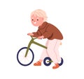 Kid riding tricycle. Cute little preschool boy on bicycle toy. Kindergarten nursery child, happy funny smiling toddler