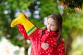 Kid with rain boots. Waterproof wear for children