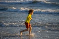 Kid running on beach having fun on summer holidays. Happy kids playing on sea. Children in nature with sea. Happy kids Royalty Free Stock Photo