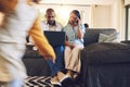 Kid running with parents on laptop with stress at their home in the living room with problems. Upset, technology and Royalty Free Stock Photo