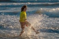 Kid running into sea water during summer holidays. Kid boy running along ocean. Child on summer beach. Child run a race Royalty Free Stock Photo