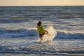 Kid running into sea water during summer holidays. Kid boy running along ocean. Child on summer beach. Child run a race Royalty Free Stock Photo