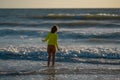 Kid running into sea water during summer holidays. Kid boy running along ocean. Child on summer beach. Child run a race Royalty Free Stock Photo