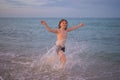 Kid running and splashing in the sea. Summer vacation. Child Running Along the summer beach. Happy excited little kid Royalty Free Stock Photo