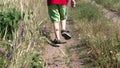 Kid runs along a dirt road