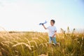 The kid runs with a toy plane. Son dreams of flying. Happy child, boy, runs on the sun playing with a toy airplane on Royalty Free Stock Photo