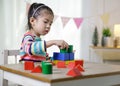 Kid`s creativity, Child little asian girl playing colorful building blocks on the desk in the class room at home, Educational Royalty Free Stock Photo