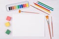 Kid`s desk with colorful pencils, brushes and watercolors, top view