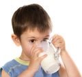 A kid's drinking some milk