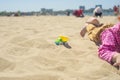 Kid`s hand playing with a toy truck in the sand Royalty Free Stock Photo