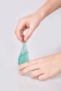 Kid`s hands holding a transparent green slime isolated