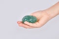 Kid`s hands holding a transparent green slime isolated