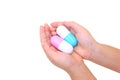 Kid`s hands holding two big capsule medicine