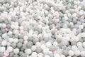 Kid's playing room interior. Pastel color white, grey, pink plastic balls background for baby activity. Copyspace