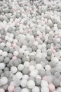 Kid's playing room interior. Pastel color white, grey, pink plastic balls background for baby activity. Copyspace