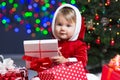 Kid Santa Claus near Christmas tree with gifts Royalty Free Stock Photo